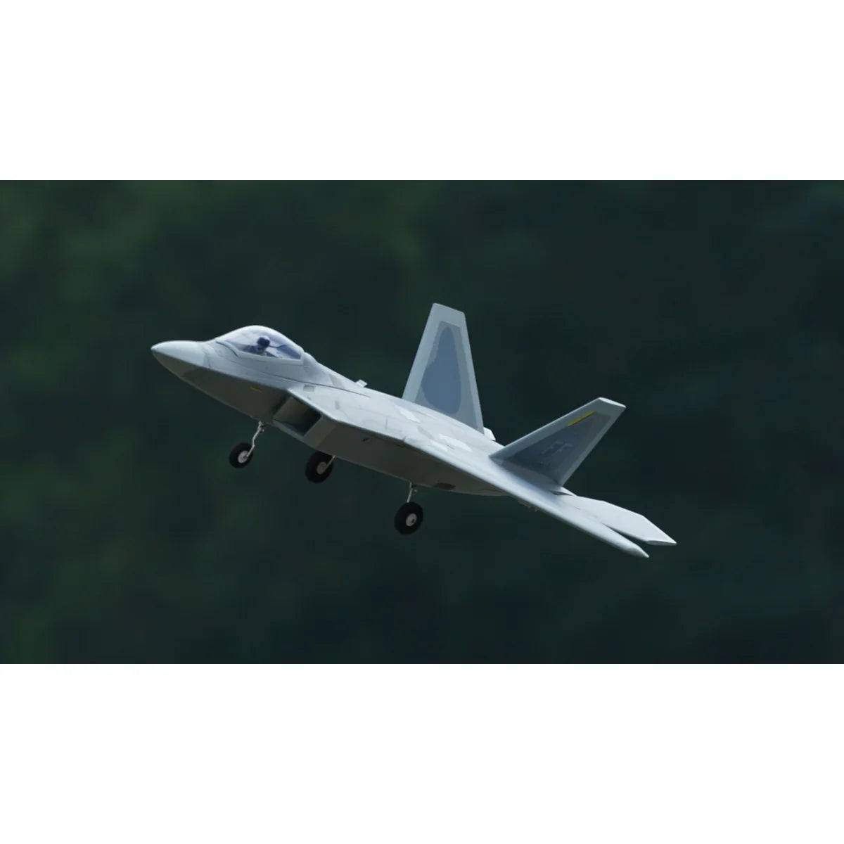 Amewi XFly F-22 Raptor Jet Twin 40mm EDF 24145 Flugzeug PNP – Seitenansicht mit eingefaehrtem Fahrwerk, vor gruener Kulisse